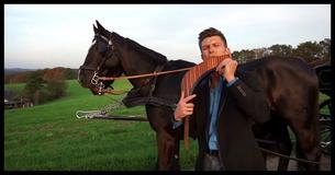 Man Standing Beside Horses Plays Pan Flute To His Chilling Version Of 'You Raise Me Up'