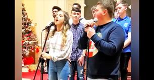 2 tieners komen het podium op om te zingen, maar wanneer meisje haar mond opent om te beginnen staat jongen versteld door haar stem