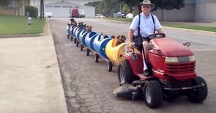 Man Drives Train Around Neighborhood With Rescued Pups In The Passenger Cars