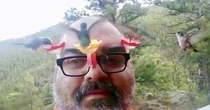 Man Attaches Mini Hummingbird Feeders To His Glasses For Close Up Footage Of The Birds