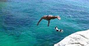 Jack Russell Diving Dog Leaps From Rocks With Her Owner