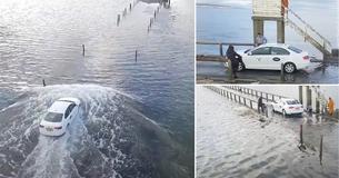 Drone Camera Captures Hilarious Moment Bumbling Taxi Driver Is Caught By Rising Tides