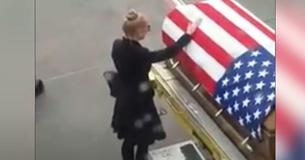 Widow Escorted Off Plane Breaks Down At Husband's Coffin, Not Realizing A Passenger Is Filming Her