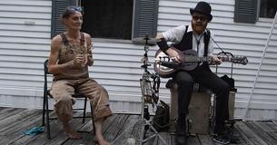 Relaxed Woman Uses Spoons To Create Music While Sitting On Her Front Porch