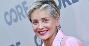 Sharon Stone Flaunts Her Painting Skills By Posing In Front Of Artwork Wearing Just A T-Shirt