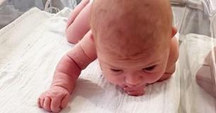 Mom Grabs Camera When Newborn Daughter Raises Her Head & Starts Crawling