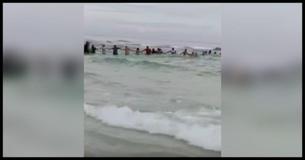 Is It A Shark? No  It's A Giant Human Chain To Save Several People From Drowning
